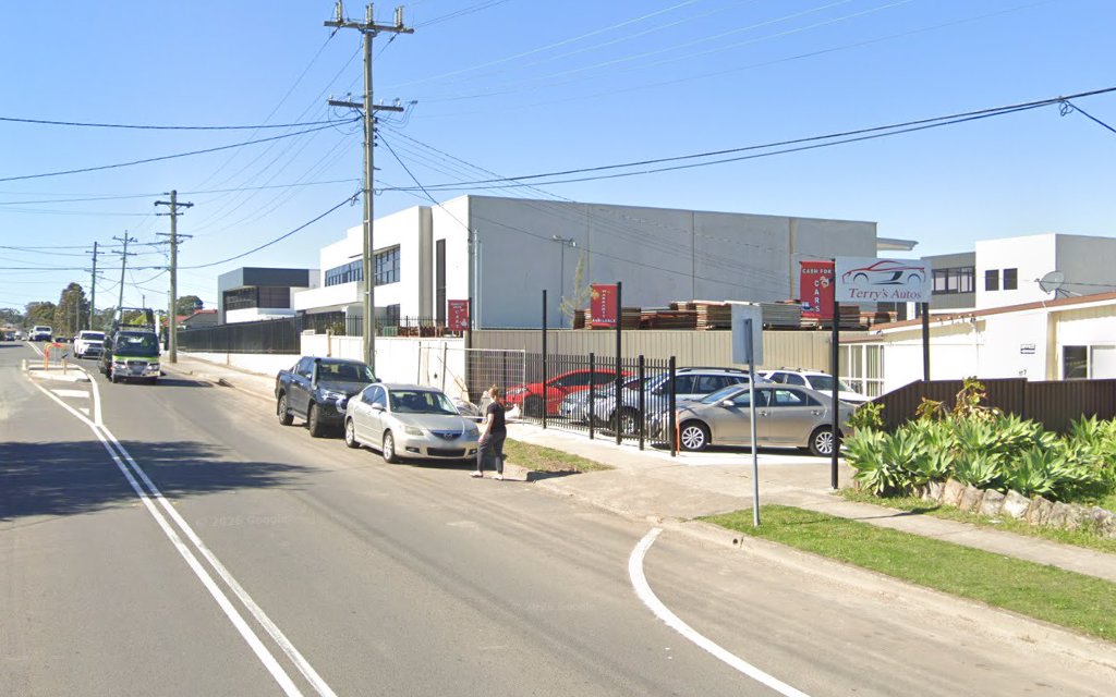 The Terry's Autos sign and CASH FOR CARS board on the fence at 117 Orchardleigh St, seen from the street
